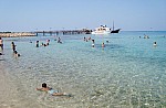 Fig Tree Bay is a scenic sandy beach in the resort of Protaras, Cyprus, with an uninhabited islet that you can swim to from the shore